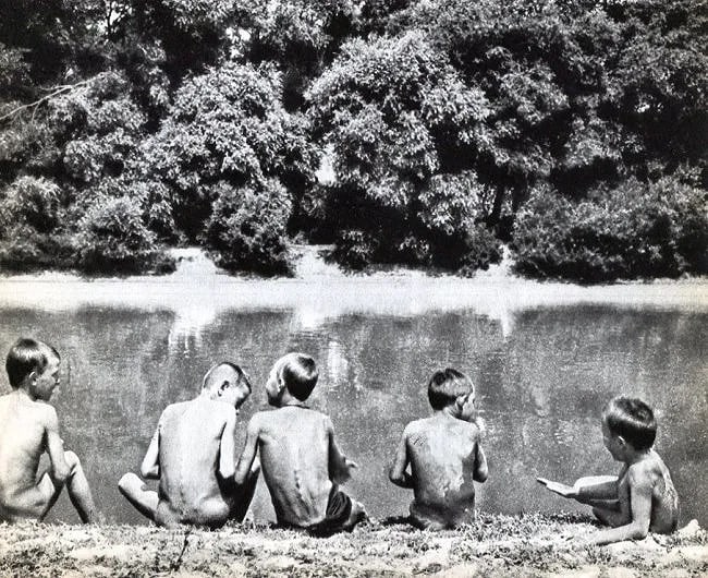 Andre Kertész (Hungarian, 1894-1985) Print: Andre Kertész (Hungarian, 1894-1985) Print. Boys on the river bank. Printed in 1933. 7.00 x 9.00 inches Not hand-signed unless otherwise stated. Photomechanical Print. Lots that contain nudity have