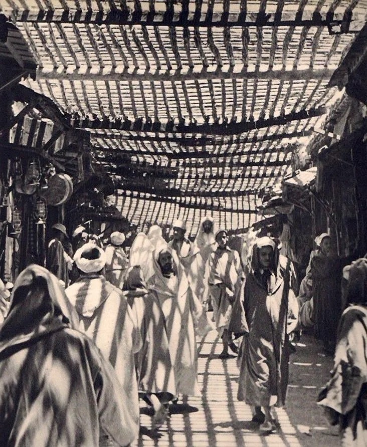 Georg Reisner Print: Georg Reisner Print. Dans le Souks Marrakech. Printed in 1937. 8.00 x 9.00 inches Not hand-signed unless otherwise stated. Photomechanical Print. Lots that contain nudity have been partially obscured 