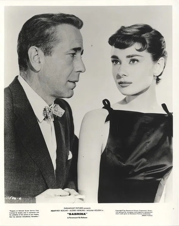 Audrey Hepburn, Humphrey Bogart Silver Gelatin: Audrey Hepburn (British, 1929–1993), Humphrey Bogart (American, 1899–1957) Silver Gelatin. 8.00 x 10.00 inches. Photomechanical Print. Lots that contain nudity have been partially obscured in the 