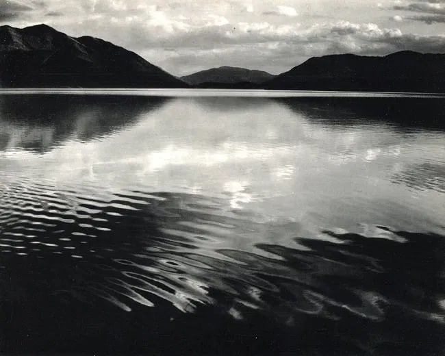 Ansel Adams (American, 1902- 1984) Print: Ansel Adams (American, 1902- 1984) Print. Lake McDonald, Glacier Ntl Park. Printed in 1960. 10.00 x 8.00 inches. Not hand-signed unless otherwise stated. Photomechanical Print. Lots that contain