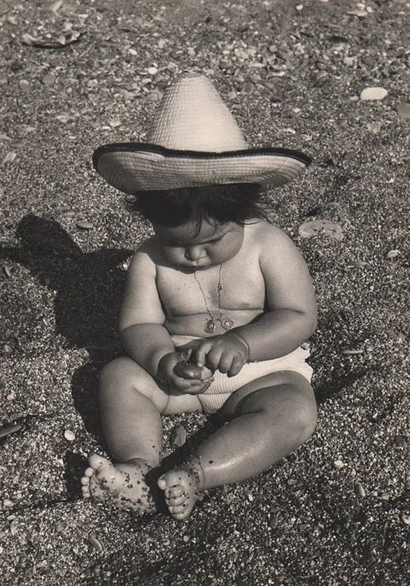 Fina Gomez Revenga (German, 1906-1989) Print: Fina Gomez Revenga (German, 1906-1989) Print. Baby with rocks. Printed in 1954. 11.00 x 15.50 inches. Not hand-signed unless otherwise stated. Photomechanical Print. Lots that contain nudity have
