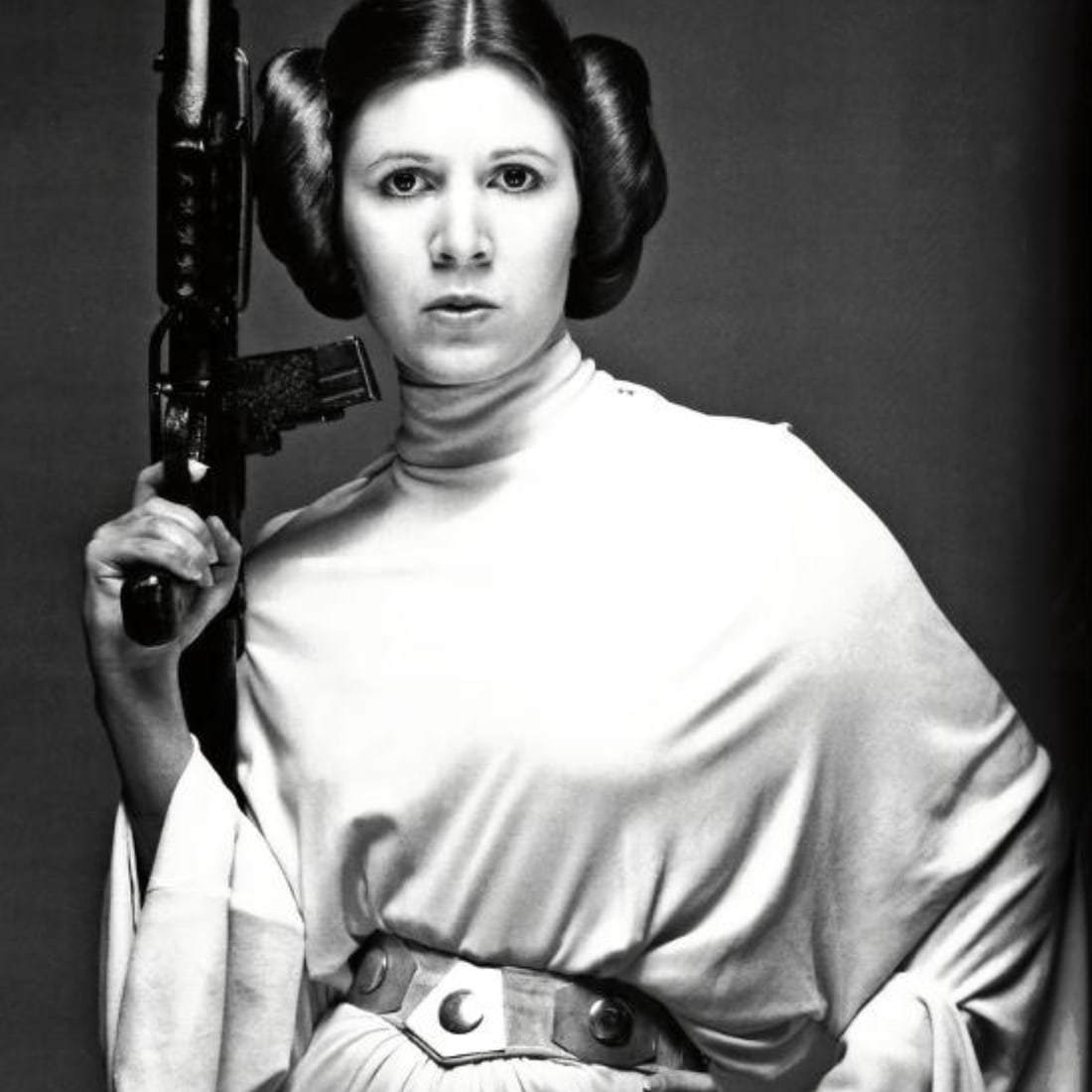 Carrie Fisher (American, 1956-2016) Print: Carrie Fisher (American, 1956-2016) Print. As Princess Leia, A New Hope. 28.50 x 29.00 inches. Not hand-signed unless otherwise stated. Photomechanical Print. Lots that contain nudity have been