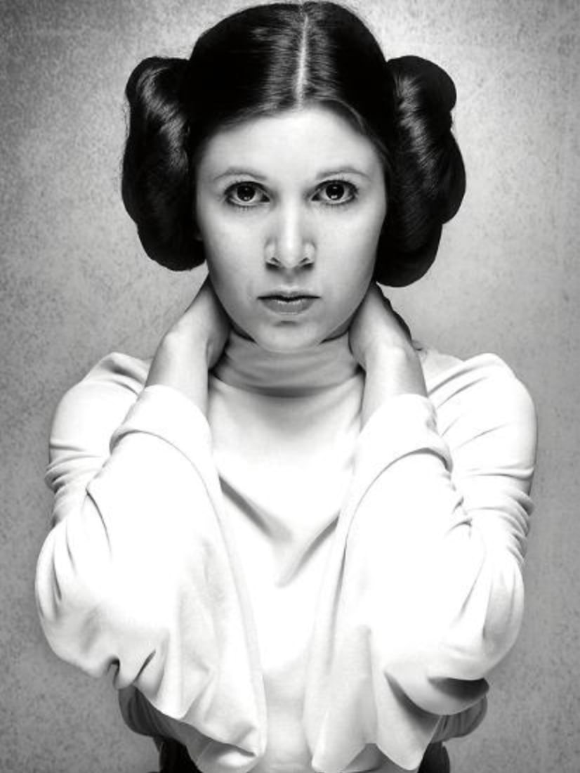 Carrie Fisher (American, 1956-2016) Print: Carrie Fisher (American, 1956-2016) Print. As Princess Leia, A New Hope. 28.50 x 38.00 inches. Not hand-signed unless otherwise stated. Photomechanical Print. Lots that contain nudity have been