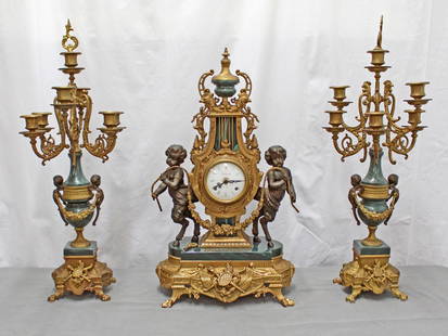 Italian Imperial Mantle Clock and Garnitures: Imperial Italy, German movement FHS. Italian Neoclassical Style Ormolu & Marble Mantel Clock with Faun. Figurative bronze and marble mantel clock with garniture having a lyre form case centered flanke
