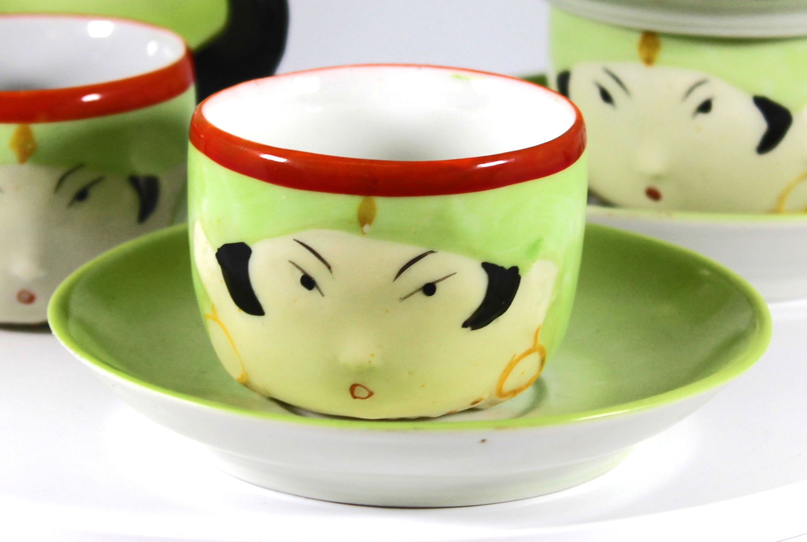 Geisha Girls Demitasse Tea Cups Set of 4: This German demitasse set of 4 tea cups and saucers are either geisha girls or Hungarian gypsies. They are the perfect size for sake, however, sake cups typically do not have handles. Too sweat and un