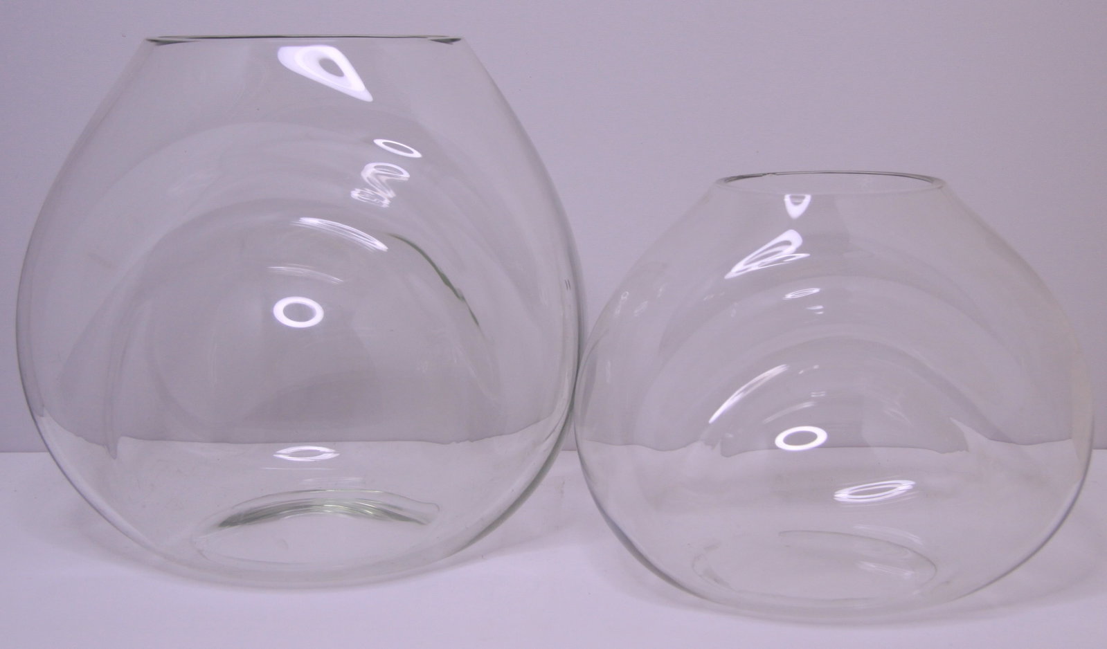 Set of 2 Scandinavian Grey Glass Dimple Vases: Set of 2 Scandinavian style lite smoked grey glass vases. A lite grey tint captures light to really accentuate the curves in the vase. These are in used but good condition with some scratches, faded