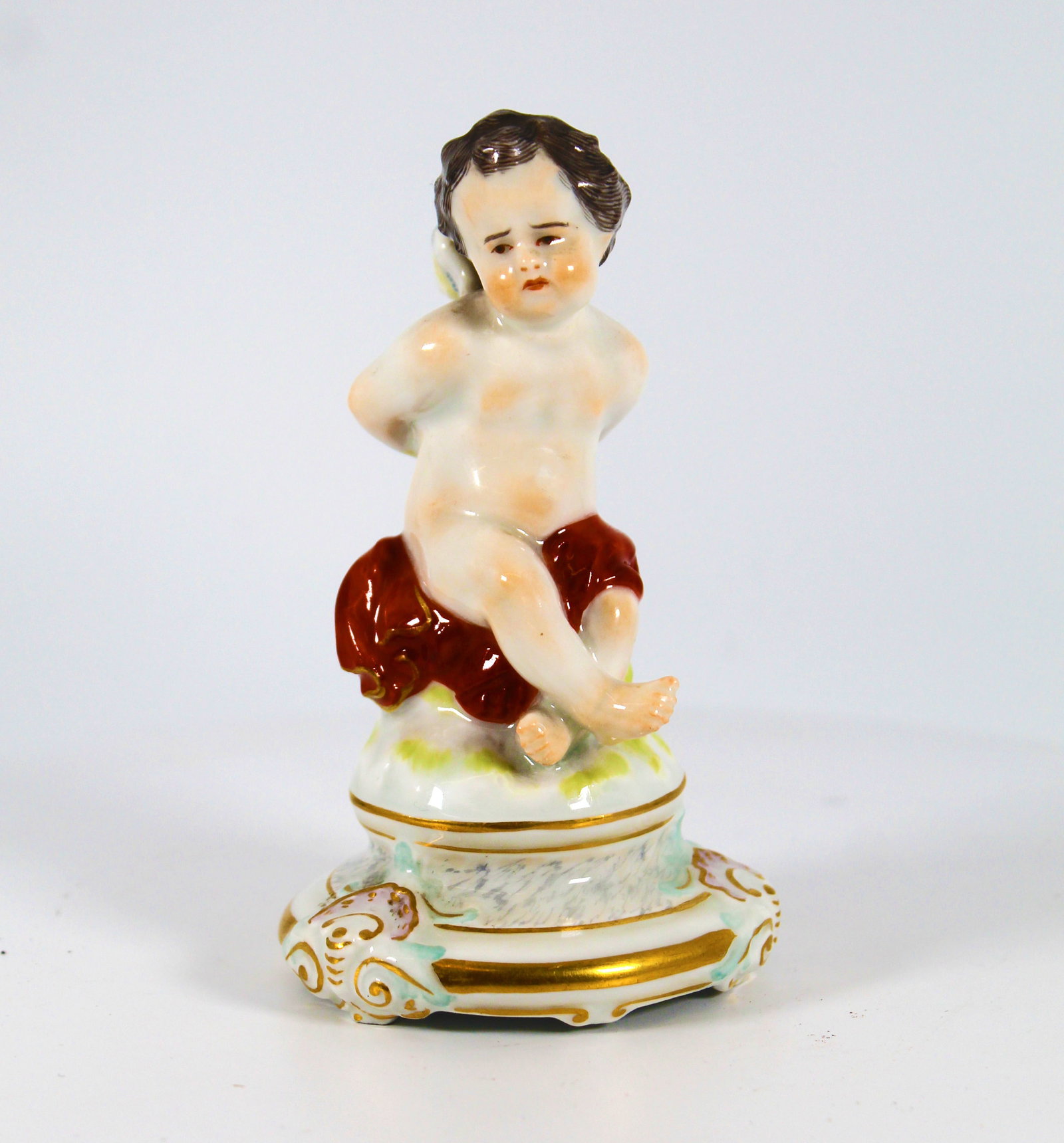 Meissen tiny 4 inch Cupid by Heinrich Schwabe: Circa 1880s to early 1900s is this 4 inch tall Meissen Cupid from the L-series of cupids by Heinrich Schwabe. Model L102 or L32 with painter's mark 23. Although Cupid wants to help you find love, his 