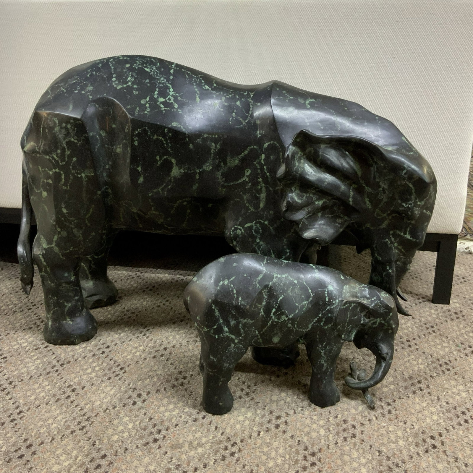 Paired Elephants Statue hollow-cast patinated bronze: Additional information coming soon. Two piece elephants paired together as a set. The baby elephant tucks into the side leg but cast separately. Artist may be Donna Mason Adams. Art deco stylized, hol