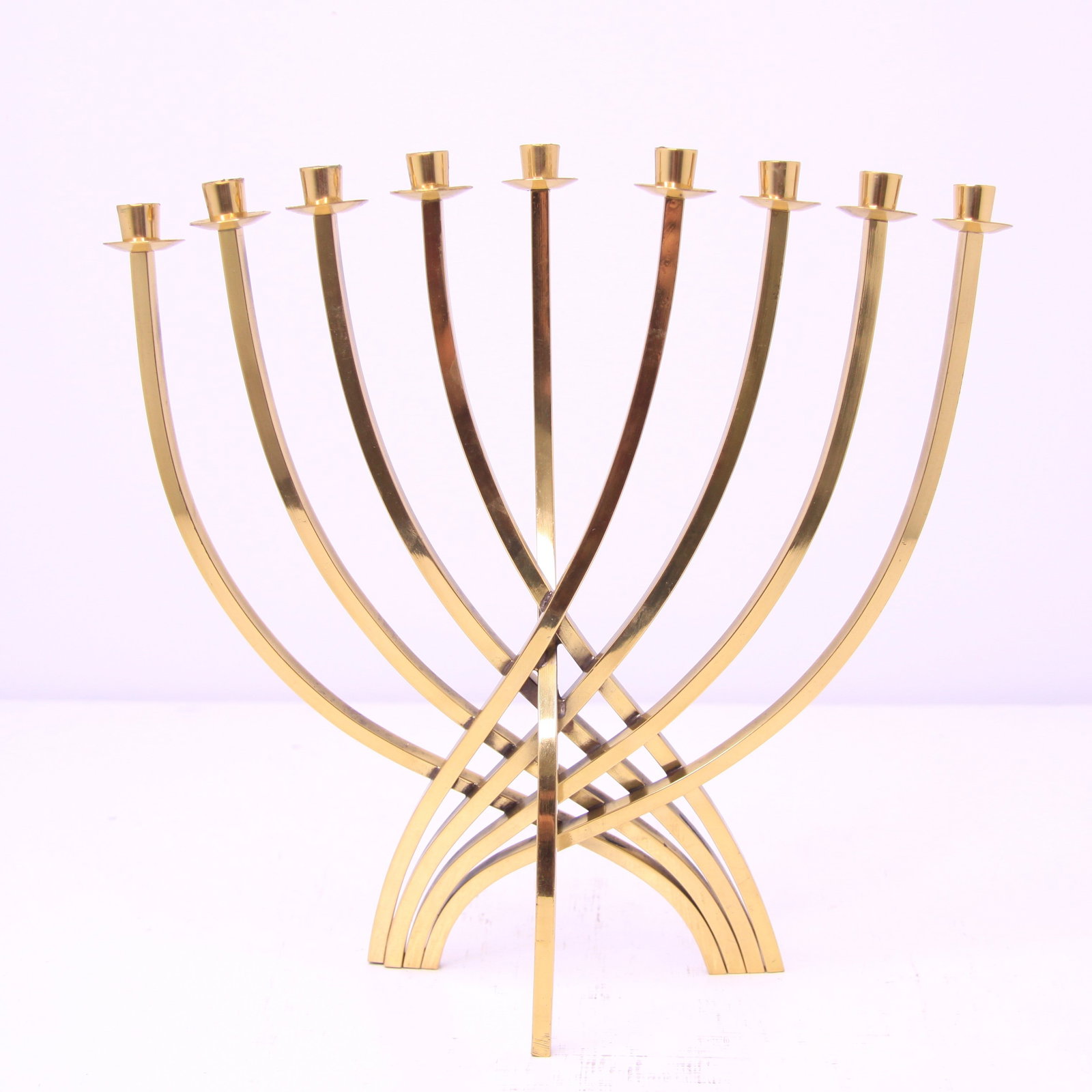 Ludwig Yehuda Wolpert Modernist Brass Hanukkah Menorah 1958 design: Ludwig Yehuda Wolpert (1900–1981) Modernist Brass Hanukkah Menorah, Design of 1958, composed of nine slender squared brass branches arranged in an elegant interlocking curvilinear form, terminating 