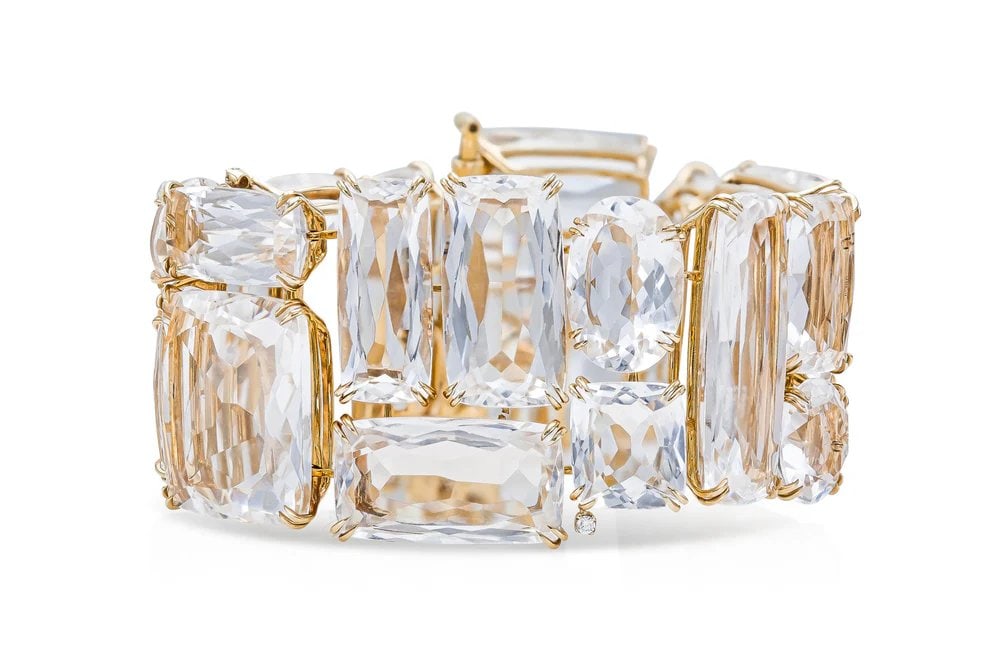 H.Stern 18k Yellow Gold Rock Crystal Bracelet: Vintage 1980s bracelet by H.Stern featuring bold faceted rock crystal panels and accent diamonds, set in luxurious 18k yellow gold. - Prong-set Rock Crystal panels - 4 Round Brilliant Diamonds - Craft