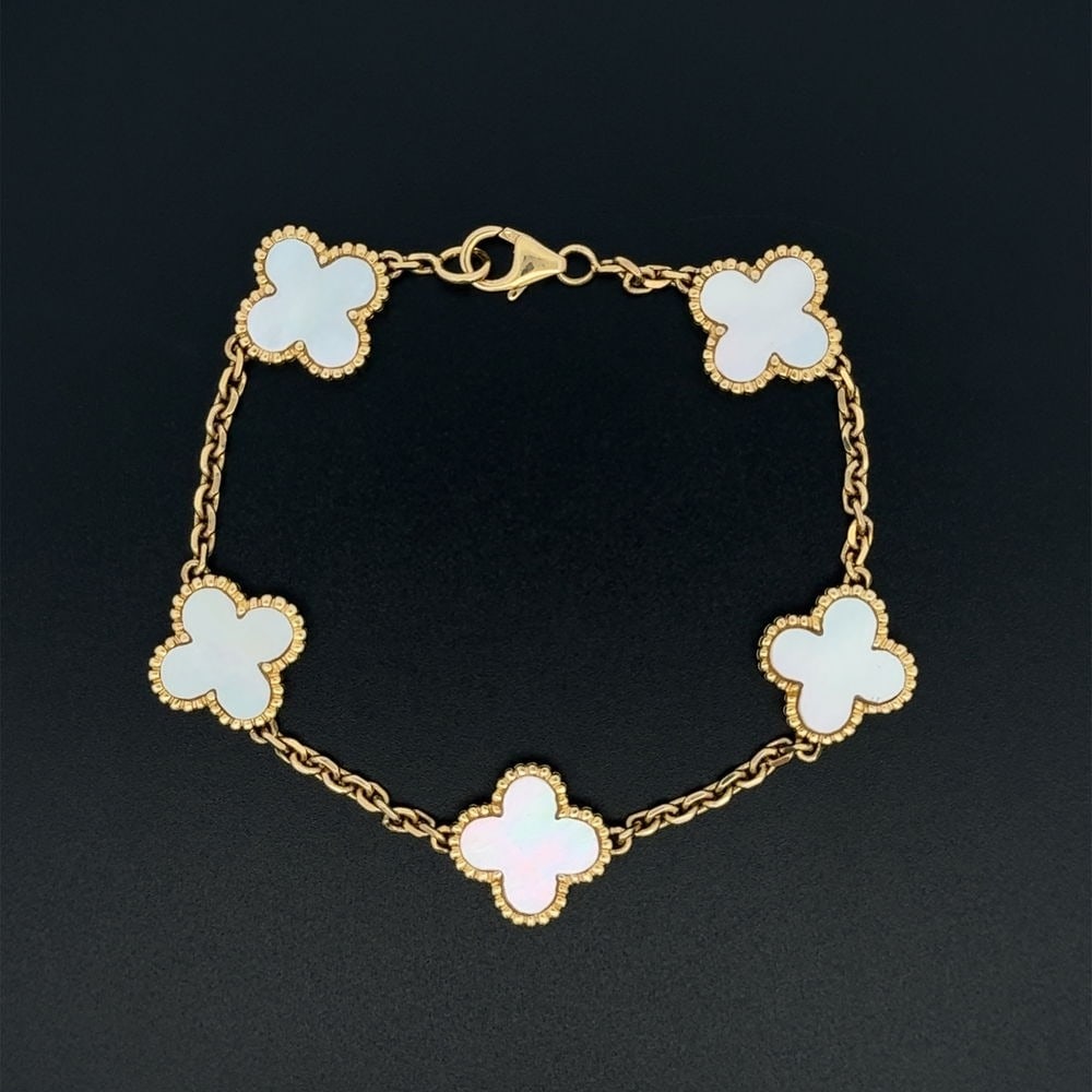 18k Gold Mother of Pearl Alhambra Bracelet: 18k yellow gold bracelet in the Alhambra style, double-sided with mother of pearl clovers. VCA-inspired design, measuring 7.5 inches and weighing 16.4 grams.- Crafted in solid 18k yellow gold- Double-