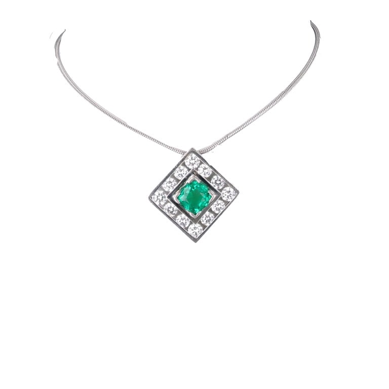 1970s Platinum Emerald Diamond Necklace: Colombian emerald and diamond necklace in platinum, circa 1970s, showcasing a vivid 1.00ct emerald and 0.68ct of diamonds in an elegant geometric setting. - Center emerald: approx. 1.00 carat - Diamon