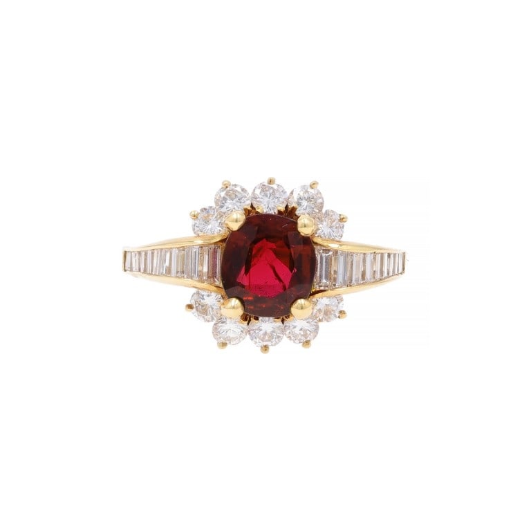 1980s 18k Gold Ruby Diamond Ring: Vintage 1980s ring in 18k yellow gold featuring a vibrant 1.35ct oval ruby framed by shimmering diamonds, a bold yet refined estate piece. - Center: Oval ruby, approx. 1.35 carats - Accented with diam