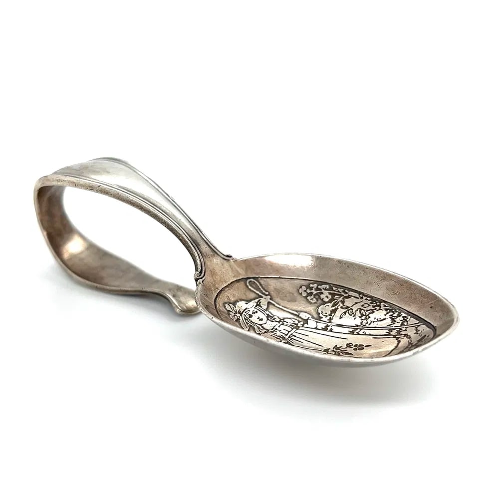 Tiffany & Co Sterling Mother Goose Baby Spoon: Vintage Tiffany & Co Mother Goose baby spoon in sterling silver, featuring nursery rhyme-themed detailing and weighing 33.3 grams. - Marked: Tiffany & Co, Sterling - Mother Goose motif design - Weight