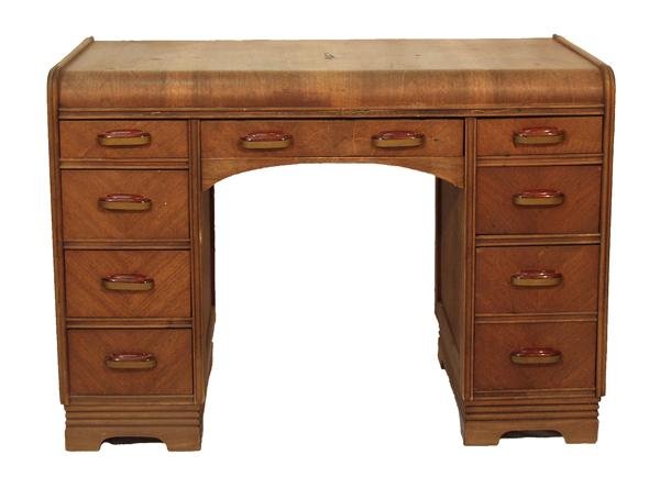 AMERICAN SCHOOL [20TH CENTURY] Furniture - Desk: American School [20th Century]. "Waterfall Pedestal Desk". Furniture - Desk. Nine drawers with a central drawer and curved apron. Damage to top veneer. 30" H x 42" L x 20" W. [20567]