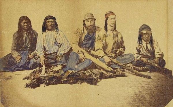 AMERICAN SCHOOL [19TH CENTURY] Vintage hand-colore: American School [19th Century]. "Apache Indians with White Traders [Arizona]". Vintage hand-colored albumen print. 1870s. Printed 1870s. 5 x 6 5/8 in. (127 x 168 mm). [97]
