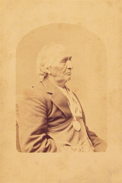 CHARLES M. BELL [ATTRIB.] (American) Vintage album: Charles M. Bell [attrib.] (American, 19th Century). "Chief of Ojibwa, in Wisconsin". Vintage albumen print. c1870. Printed c1870. Titled in ink on mount, recto. 7 1/2 x 5 in. (190 x 127 mm). [152]