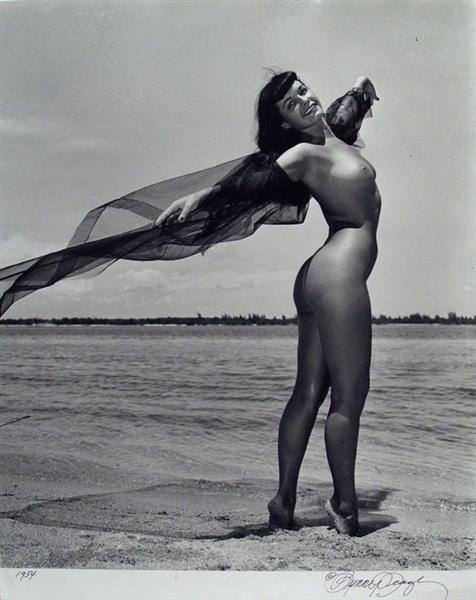BUNNY YEAGER (American) Vintage gelatin silver pr: Bunny Yeager (American, b.1930). "Bettie Page, Miami". Vintage gelatin silver print. 1954. Printed 1954. Signed in pen, lower right; dated in pen, lower left. Photographer's stamp on verso, along with