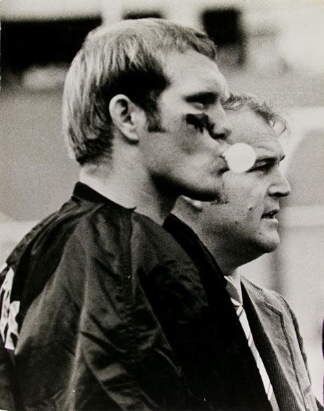 MORRIS BERMAN (American) Gelatin silver print: Morris Berman (American, 1910 - 2002). "Bubble Blowing Hero [Terry Bradshaw with Chuck Noll]". Gelatin silver print. 1970s. Printed 1970s. Signed, titled and estate stamped, verso. 19 5/16 x 15 3/8 in