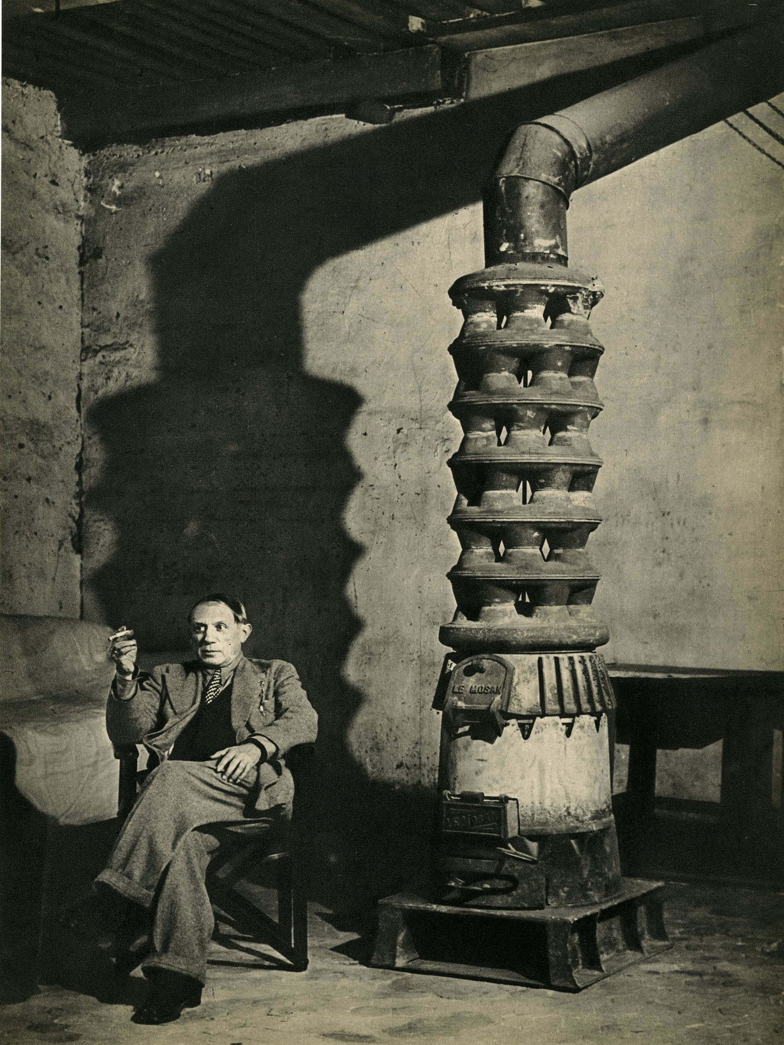 BRASSAI [gyula halasz] - Picasso dans son atelier: Artist: Brassai [gyula halasz] (Hungarian/French, 1899-1984). Title: "Picasso dans son atelier près du poêle, rue des Grands Augustins". Medium: Original vintage photogravure. Date: Composed