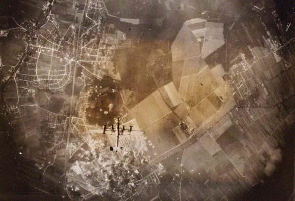 U.S. ARMY SIGNAL CORPS (American) Vintage gelatin: U.S. Army Signal Corps (American, 20th Century). "U.S. B-24 Liberator Wings Over German Target". Vintage gelatin silver print. 1944. Printed 1944. Extensive notations in letters, verso. 4 3/16 x 6 1/1