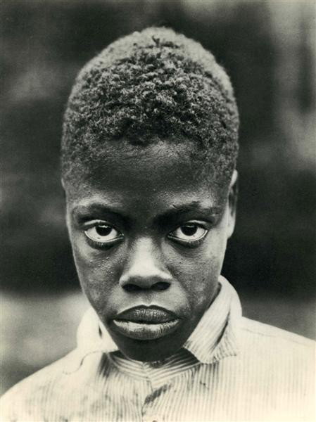 MARGARET BOURKE-WHITE - Original vintage photograv: Margaret Bourke-White (American, 1904 - 1971). "Portrait of a Negro Boy". Original vintage photogravure. c1934. Printed 1935. 11 1/2 x 8 5/8 in. (292 x 219 mm). [24151]