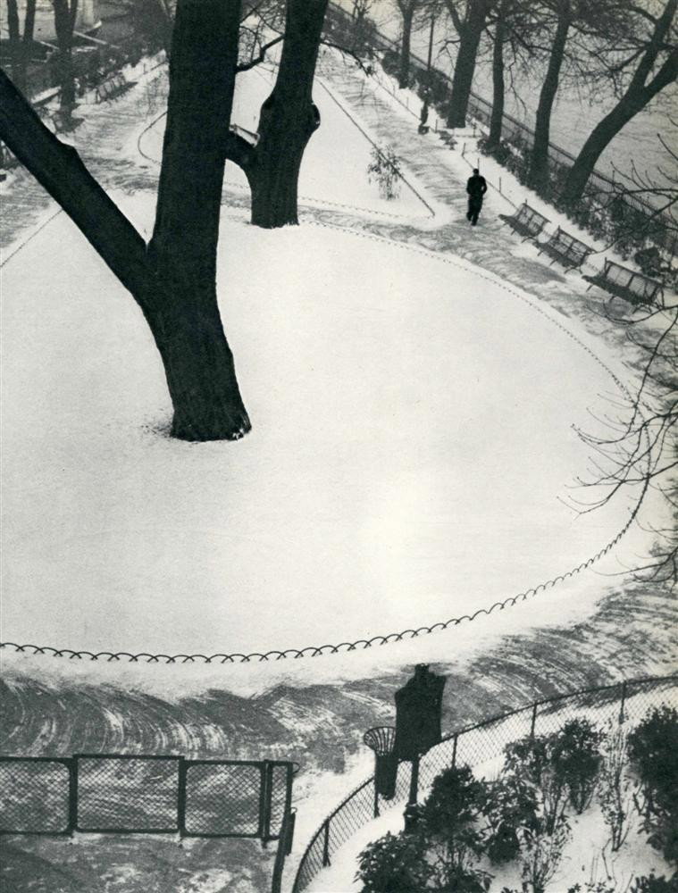 ANDRE KERTESZ - Original vintage photogravure: Andre Kertesz (Hungarian/American, 1894-1985). "Square sous la neige". Original vintage photogravure. c1935. Printed 1935. Image size: 9 9/16 x 7 3/8 in. (243 x 187 mm). [23829]