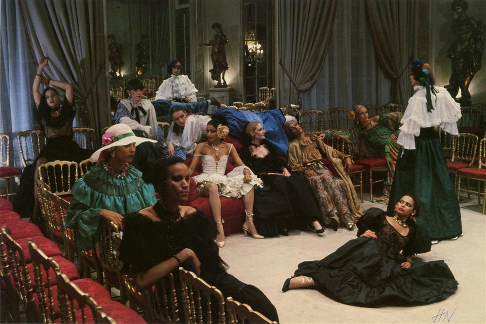 HELMUT NEWTON - Color photolithograph: Helmut Newton (German/Australian, 1920-2004). "Chez Yves Saint Laurent, French Vogue [Paris]". Color photolithograph. 1977. Signed with the initials in pen, lower right. Fine, quality printing. Very g
