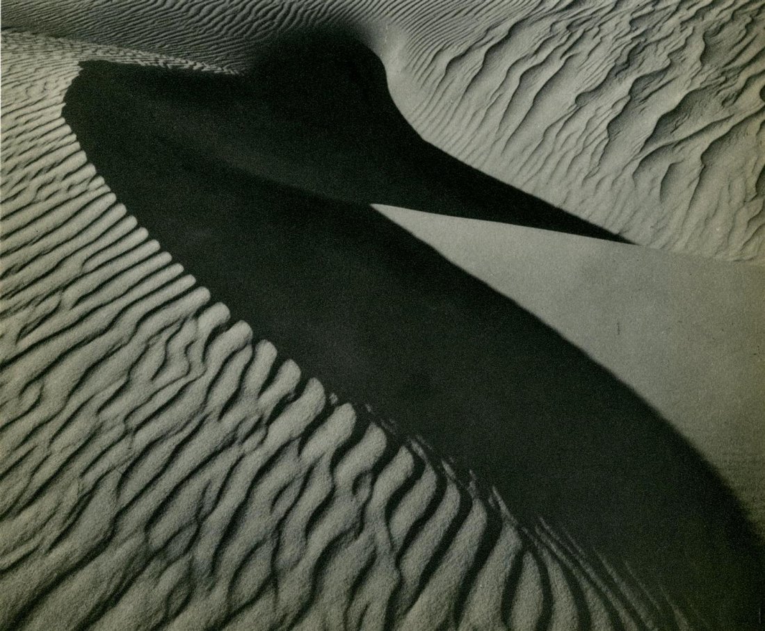 BRETT WESTON - Original vintage photogravure: Brett Weston (American, 1911-1993). "Sand Dunes". Original vintage photogravure. c1934. Printed 1935. Fine, quality printing. Very good condition; affixed to mount. Image size: 7 x 8 3/8 in. (178 x 21