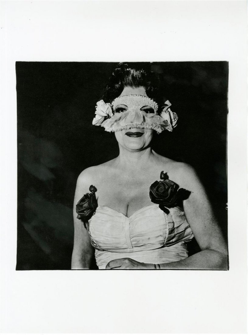DIANE ARBUS - Original photogravure: Diane Arbus (American, 1923-1971). "Lady at a Masked Ball with Two Roses on Her Dress, New York". Original photogravure. 1967. Printed 1978. Fine condition; with tissue guard. Overall size: 15 3/4 x 1