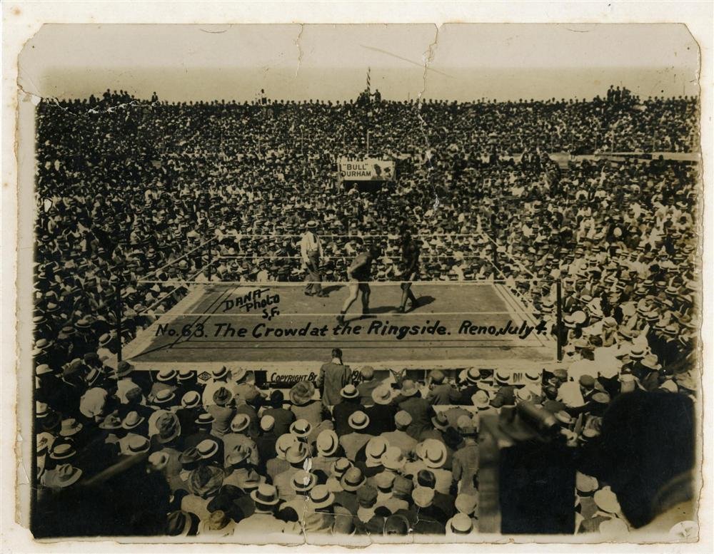 DANA PHOTO - Vintage albumen print: Dana Photo (American, act.1900-1920). "Jack Johnson vs. Jim Jeffries Boxing Match ["The Crowd at the Ringside. Reno, July 4th]". Vintage albumen print. 1910. Printed 1910. Signed in the image. Fair co