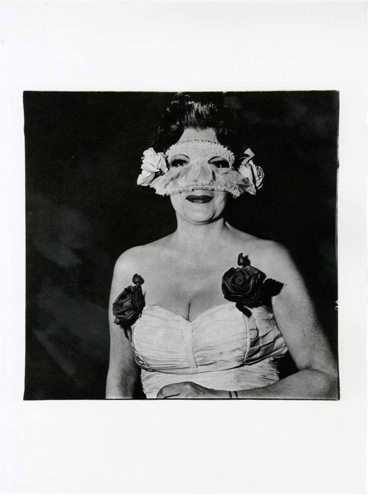 DIANE ARBUS - Original photogravure: Diane Arbus (American, 1923-1971). "Lady at a Masked Ball with Two Roses on Her Dress, New York". Original photogravure. 1967. Printed 1978. Fine condition; with tissue guard. Overall size: 15 3/4 x 1