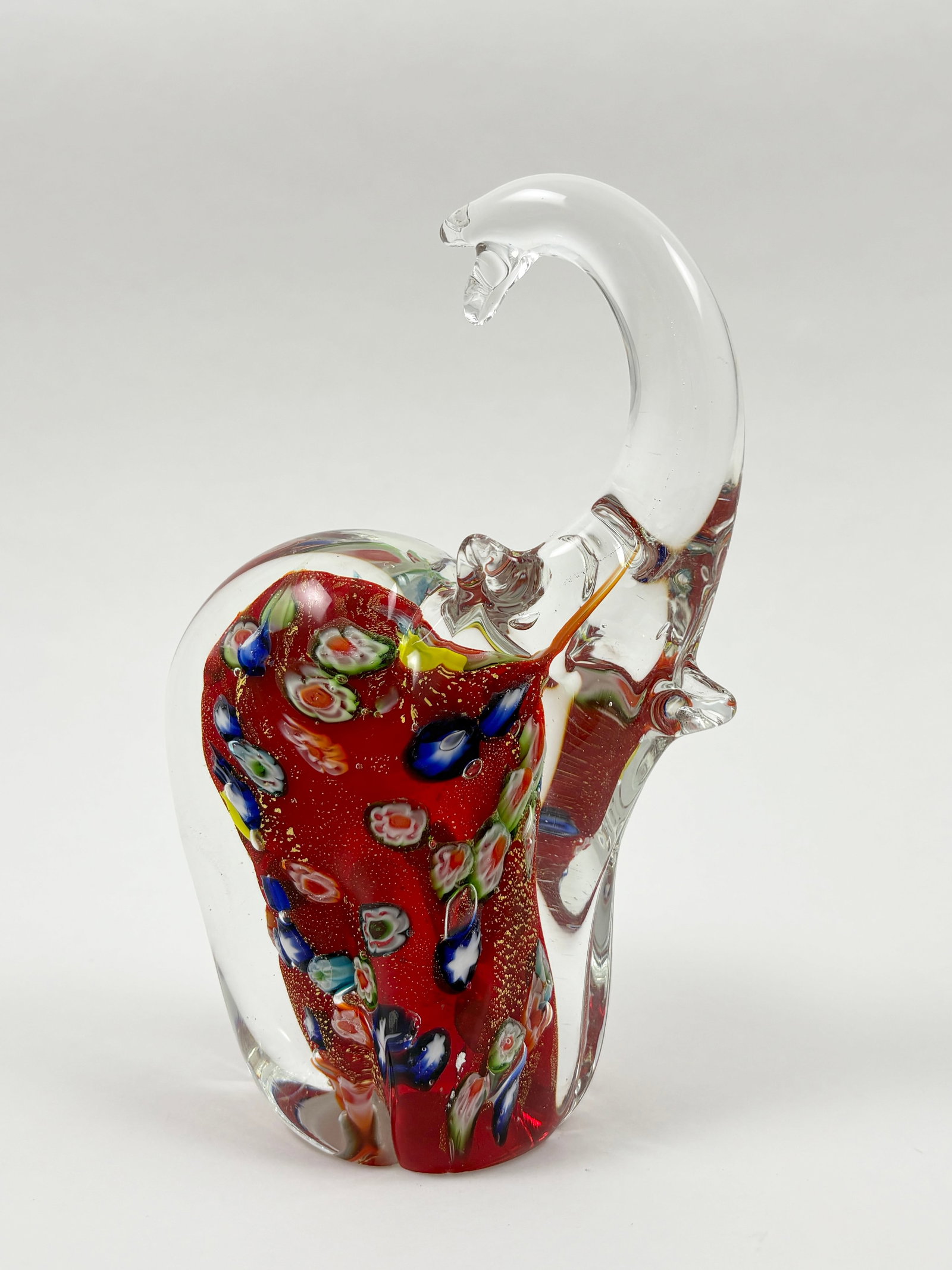 Murano Art Glass Elephant Sculpture, Millefiori Style (6.75 in): MURANO Art Glass Elephant Sculpture Blown glass, Millefiori-style detailing A vibrant example of Murano-style craftsmanship, this hand-blown glass elephant features rich red coloring infused with mult