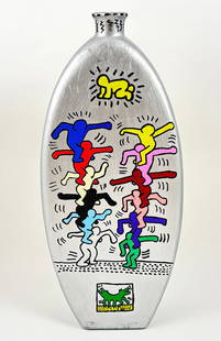 Keith Haring - Hand Painted Vase, 1987 Attrib.: Attributed to KEITH HARING (1958–1990) Hand-Painted Vase Paint on Metal Sculpture Height: 18 inches Vibrant and visually striking metal vase hand-painted with Keith Haring’s iconic figures in a dy