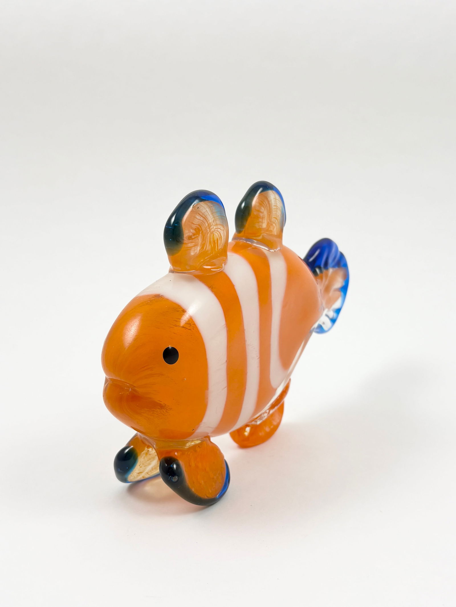Murano-Style Art Glass Clownfish Sculpture, 8 Inches Wide: MURANO Art Glass Clownfish Sculpture A vibrant hand-blown glass sculpture in the style of Murano, modeled as a clownfish with orange, white, and blue accents. Features playful, rounded fins and expres