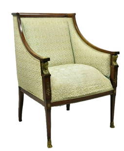 Antique 19th Century French Empire Mahogany Bergère Armchair with Ormolu Detail: Antique 19th Century French Empire Mahogany Bergère Armchair This refined French Empire armchair features a solid mahogany frame with elegant, tapered legs and classic Empire lines. The standout elem