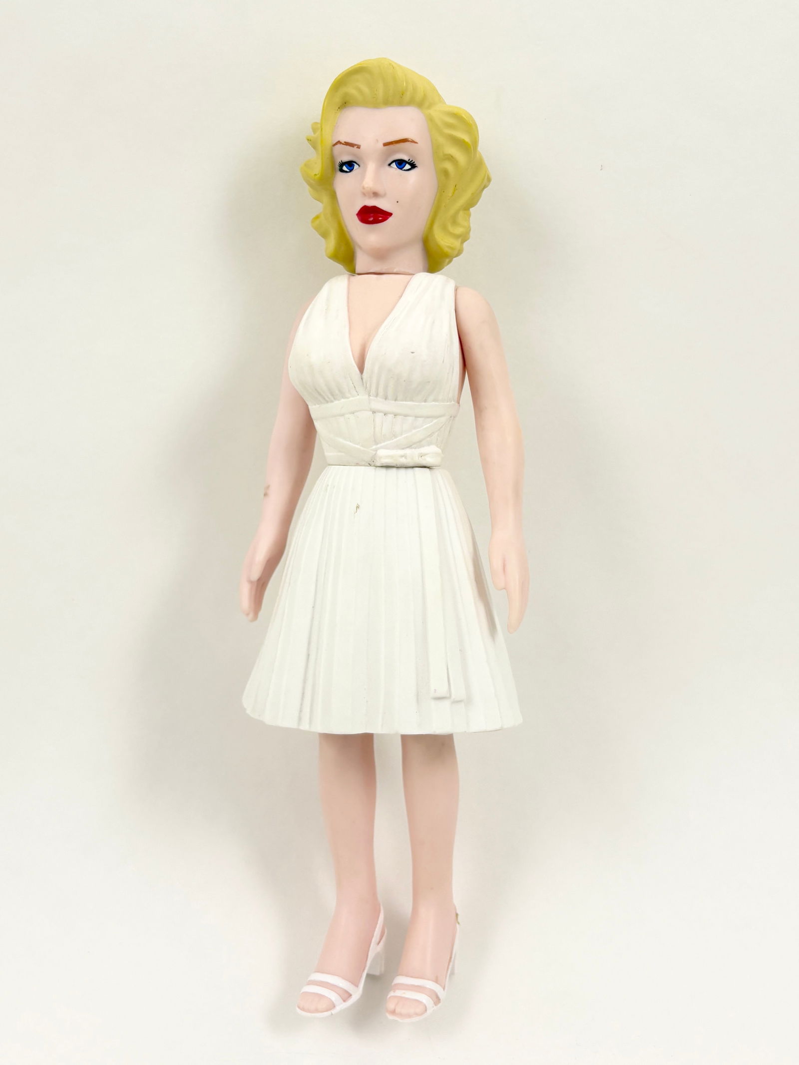 Marilyn Monroe - Figure: Marilyn Monroe, Figure Figure Height: 10 inches A Marilyn Monroe figure depicted standing in a white dress.