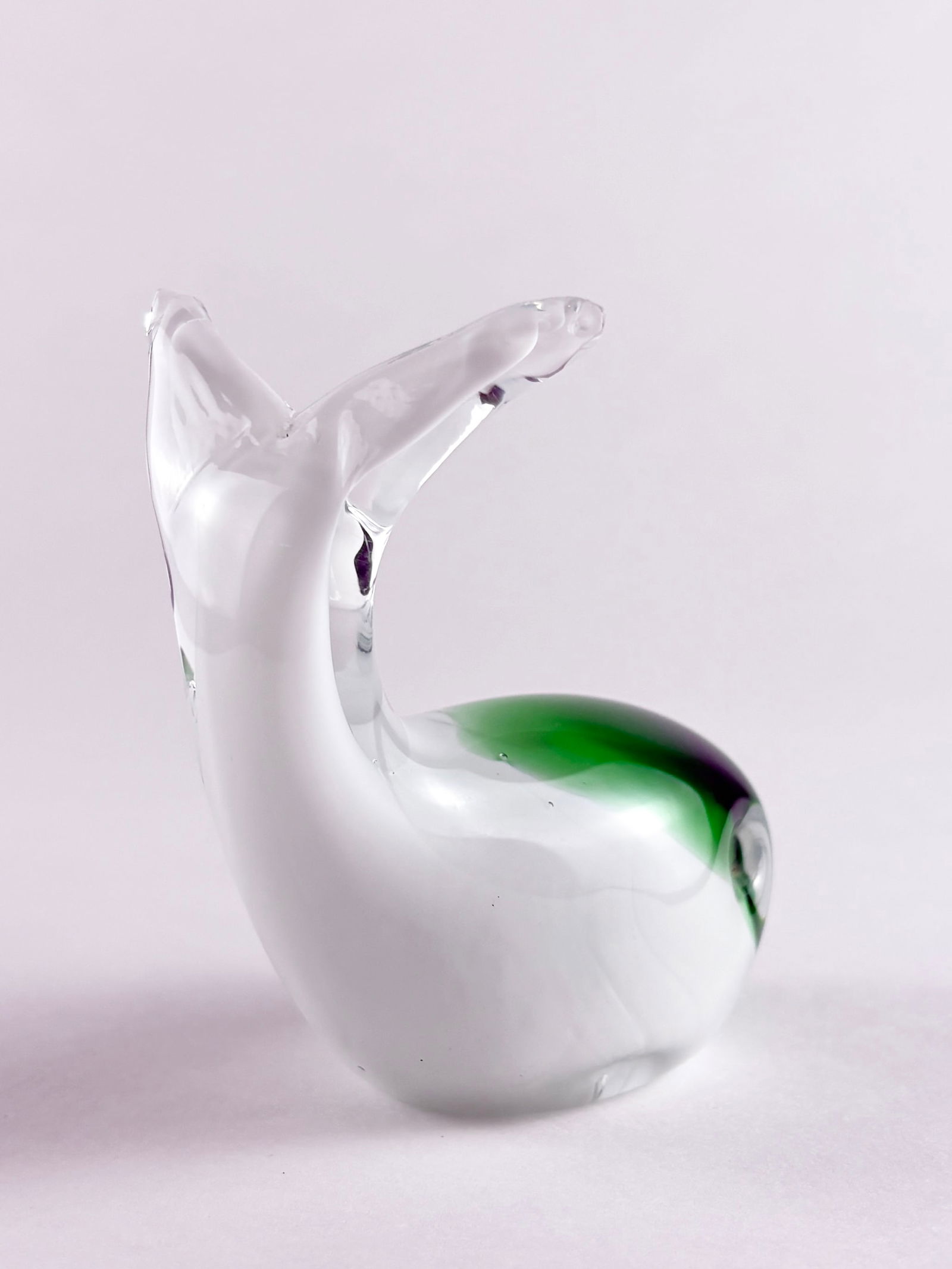 Mini Art Glass Whale Sculpture: Art Glass Whale, Glass Whale Sculpture Glass Height: 3.5 inches A small decorative art glass whale with a clear and white body accented by a green glass detail.