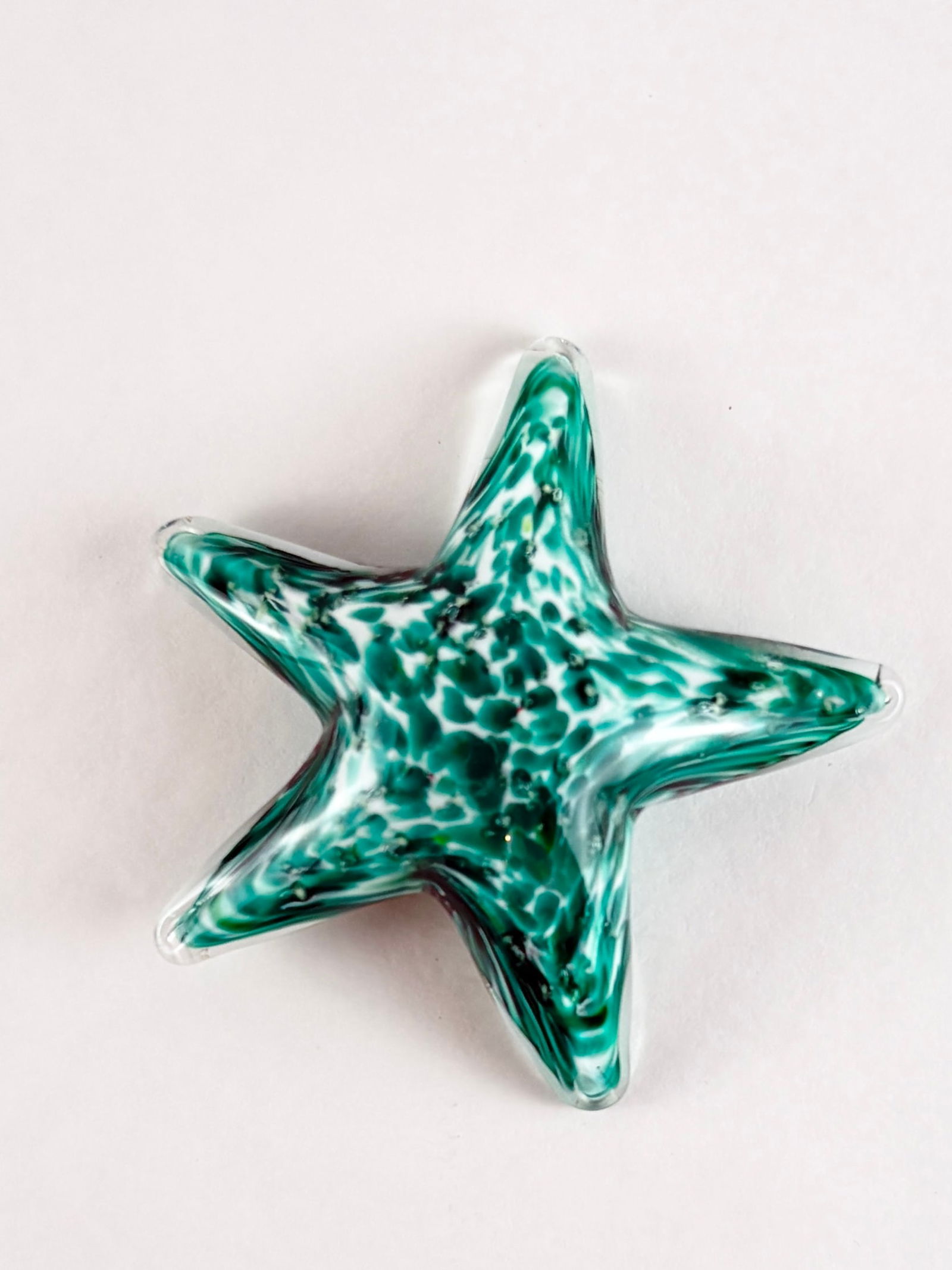 Mini Art Glass Starfish Sculpture: Art Glass Starfish, Glass Starfish Sculpture Glass Height: 4 inches Decorative art glass starfish sculpture featuring a five-pointed form with green and white mottled internal patterning. Compact