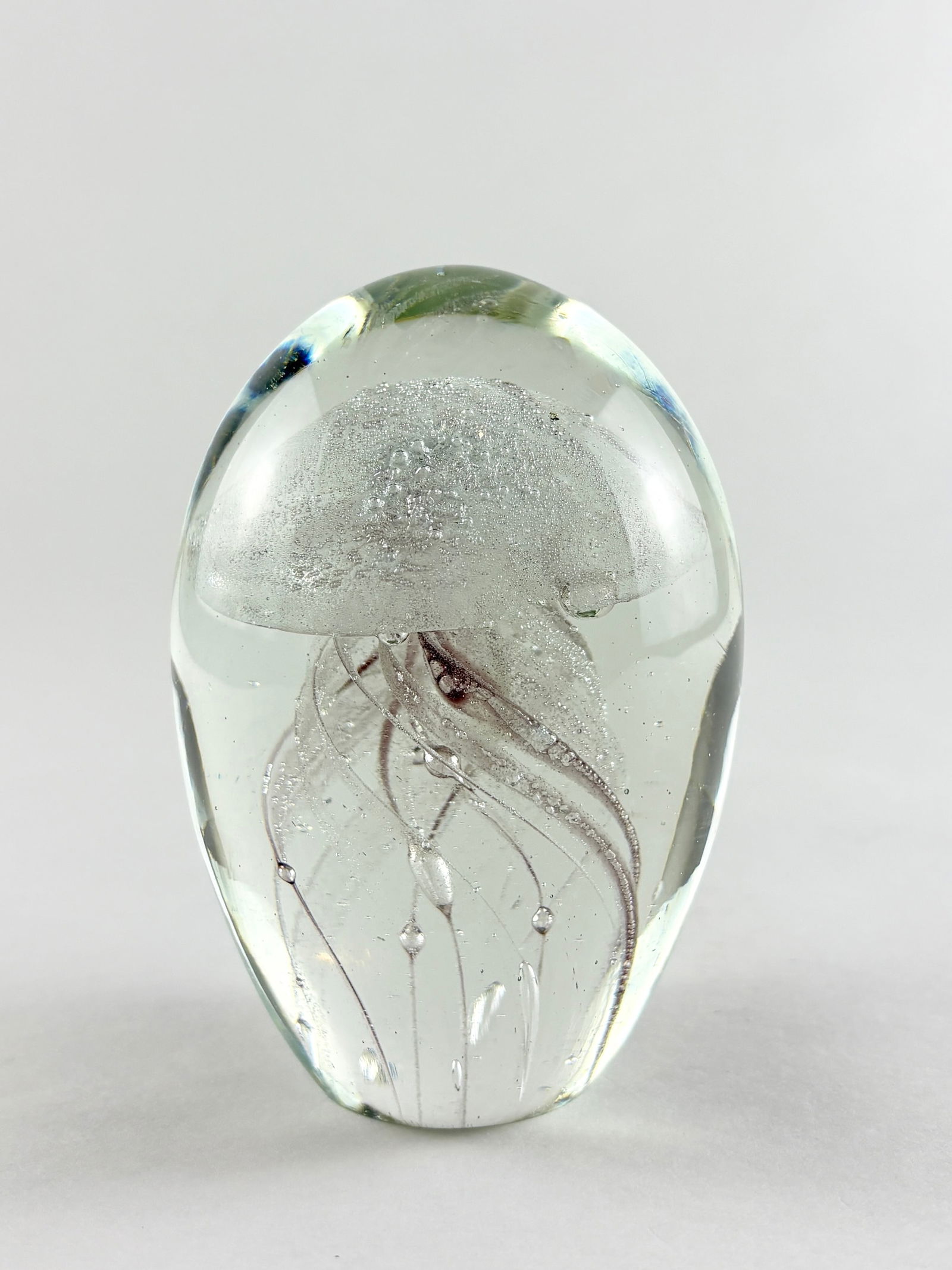 Glass Jellyfish Sculpture (Murano Style): Decorative art glass jellyfish sculpture formed in clear glass with an encased dome top and suspended internal tendrils creating a floating, organic effect. The controlled bubbles, internal