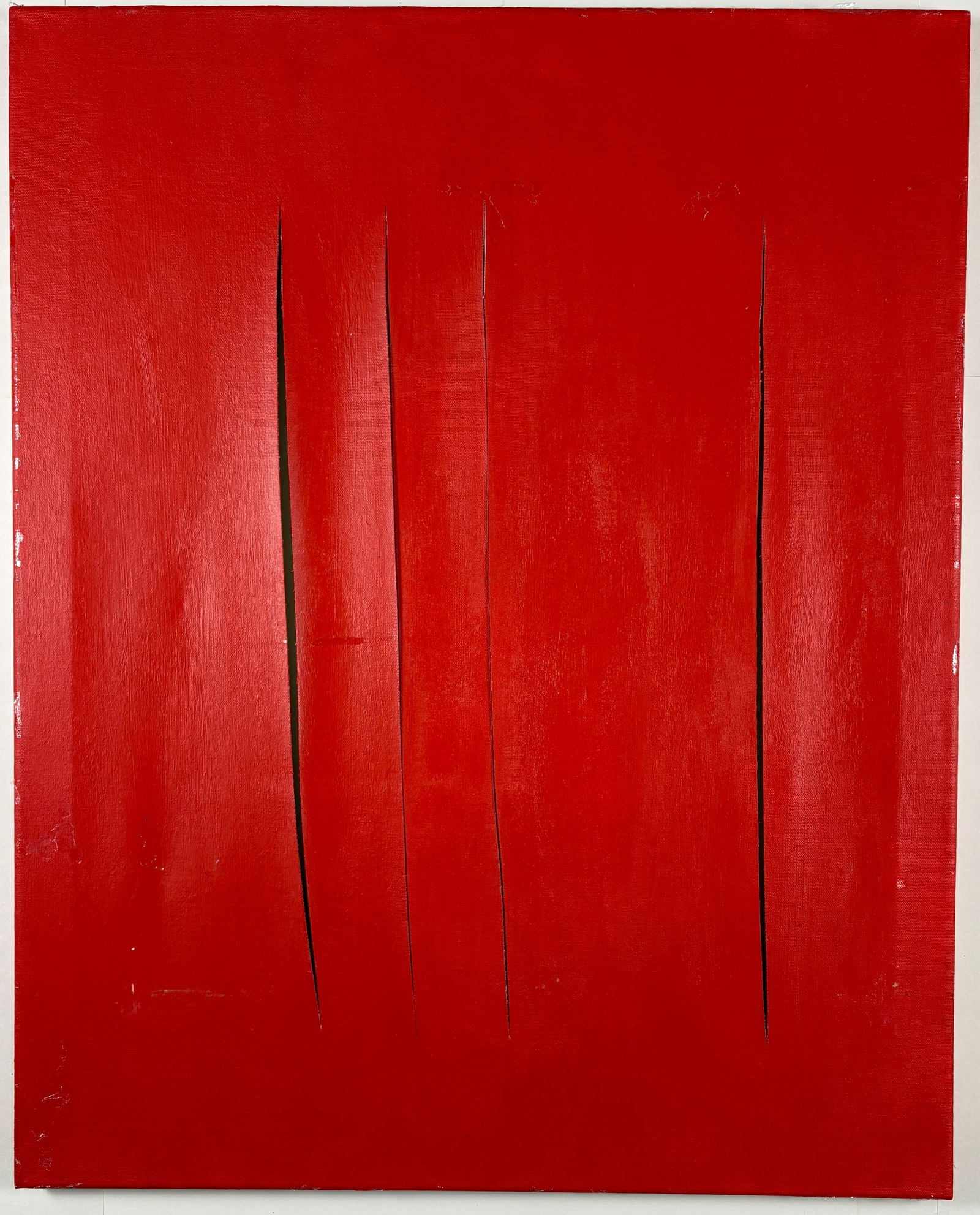 Untitled Red Cut Canvas, Style of Lucio Fontana: UNKNOWN ARTIST Untitled Oil on canvas Abstract composition executed in a monochromatic red palette, featuring deliberate vertical slashes through the canvas surface. The work is clearly inspired by