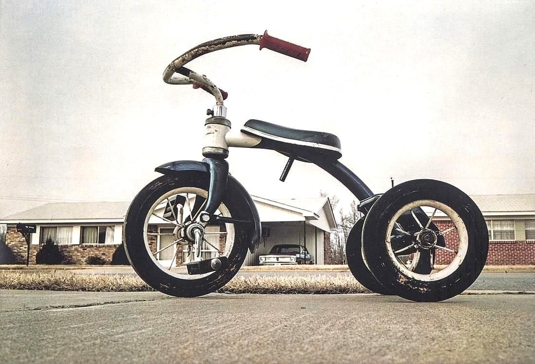 William Eggleston - Tricycle, 1971: William Eggleston (b. 1939), Tricycle, 1971 1971 color print 4.75 × 7 inches (approx.) A classic image by William Eggleston, capturing a child’s tricycle monumentalized through the artist’s dist