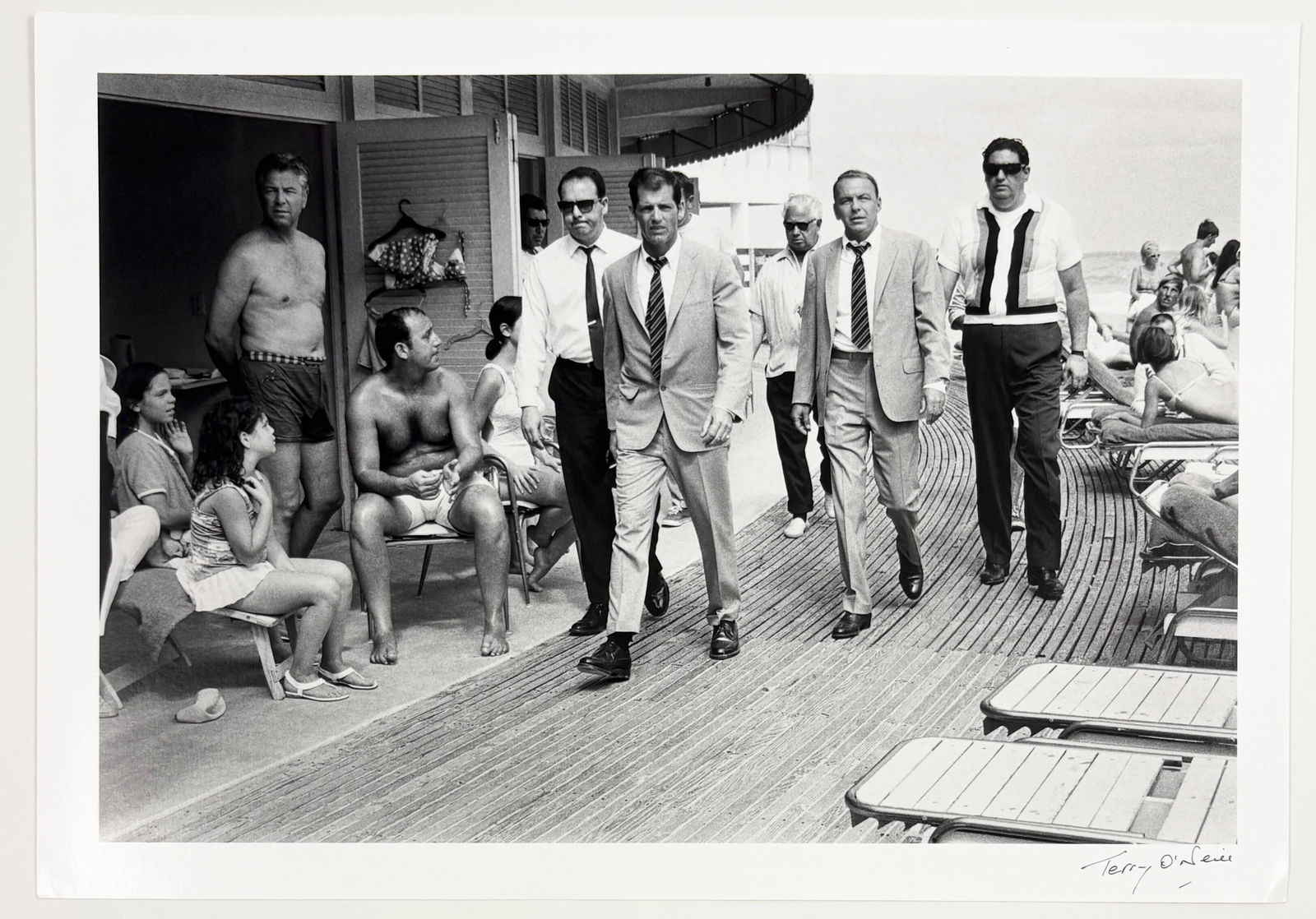 Terry O’Neill – Frank Sinatra, Miami Beach, 1968: Terry O’Neill (1938–2019) Frank Sinatra, Miami Beach 1968 photographic print plate signed 12 x 8 in. Black-and-white photographic print depicting Frank Sinatra walking through a poolside setting i