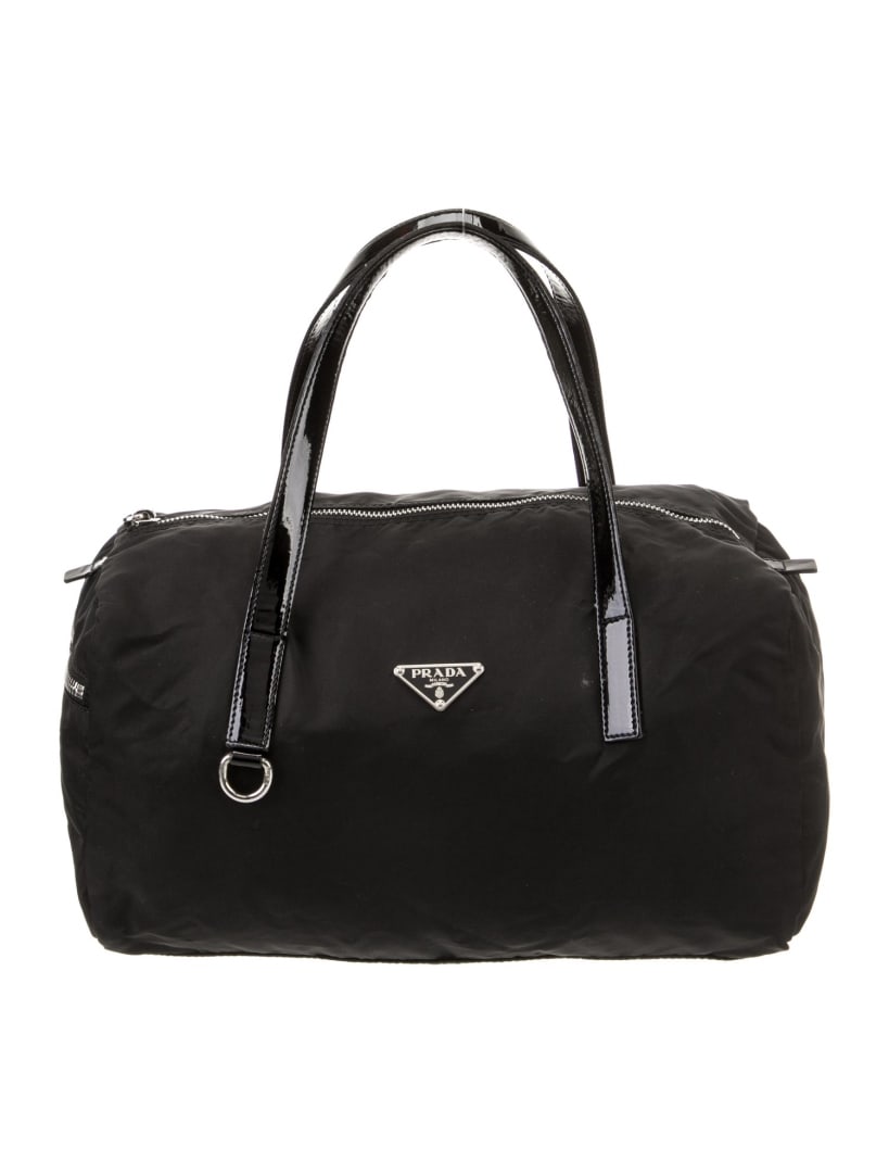 Prada Vela Nylon Silver-tone Hdw Top Handle Bag: Condition is very good, pre-owned. Details: nero tessuto, vela nylon & enameled metal triangle, silver-tone hardware, patent leather trim, flat handles, unlined, zip closure at top, shoulder strap dro