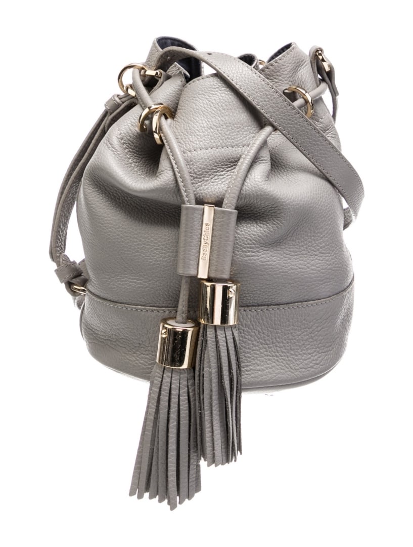 See By Chloe Grey Lthr Drawstring Cls Bucket Bag: Condition is: good, pre-owned. Details: grey leather, gold-tone hardware, single adjustable shoulder strap, tassel accents, twill lining & three interior pockets, drawstring closure at front, shoulder