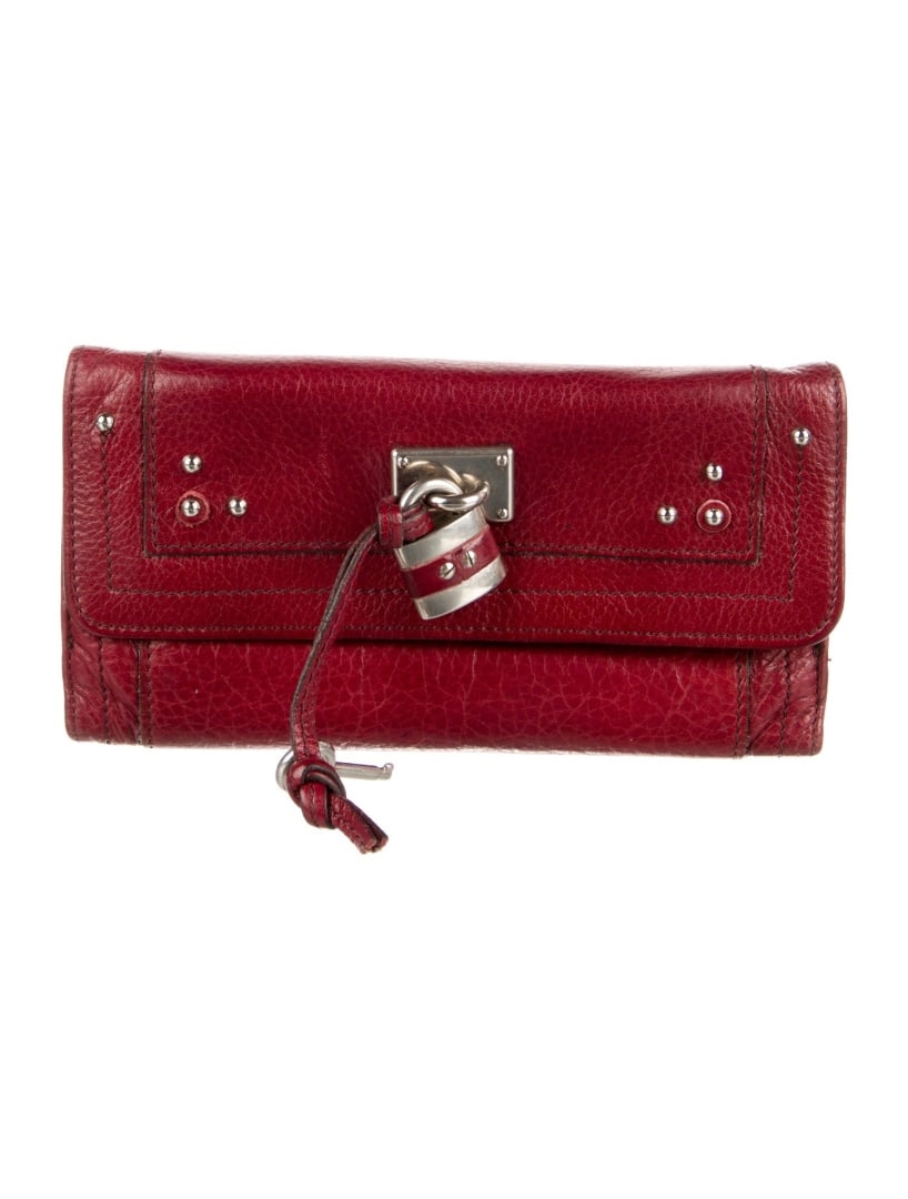 Chloe Red Leather Studded Accents Cntl Wallet: Condition is very good, pre-owned. Details: red leather, silver-tone hardware, studded accents & three exterior pockets, leather lining & three interior pockets with card slots, snap closure, includes