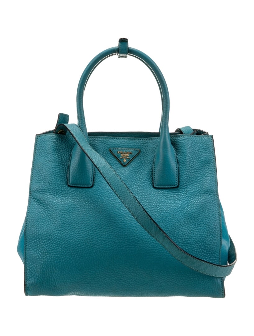 Prada Blue Vitello Daino Leather Snap Top Hdl Bag: Condition is: good, pre-owned. Details: blue vitello daino leather, vitello daino leather, gold-tone hardware, rolled handles & single adjustable shoulder strap, logo jacquard lining & dual interior p