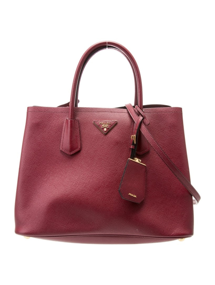 Prada Cerise Saffiano Cuir Leather Top Hdl Bag: Condition is good, pre-owned. Details: cerise saffiano cuir leather, gold-tone hardware, rolled handles & single adjustable shoulder strap, leather lining & single interior pocket, open top, protectiv