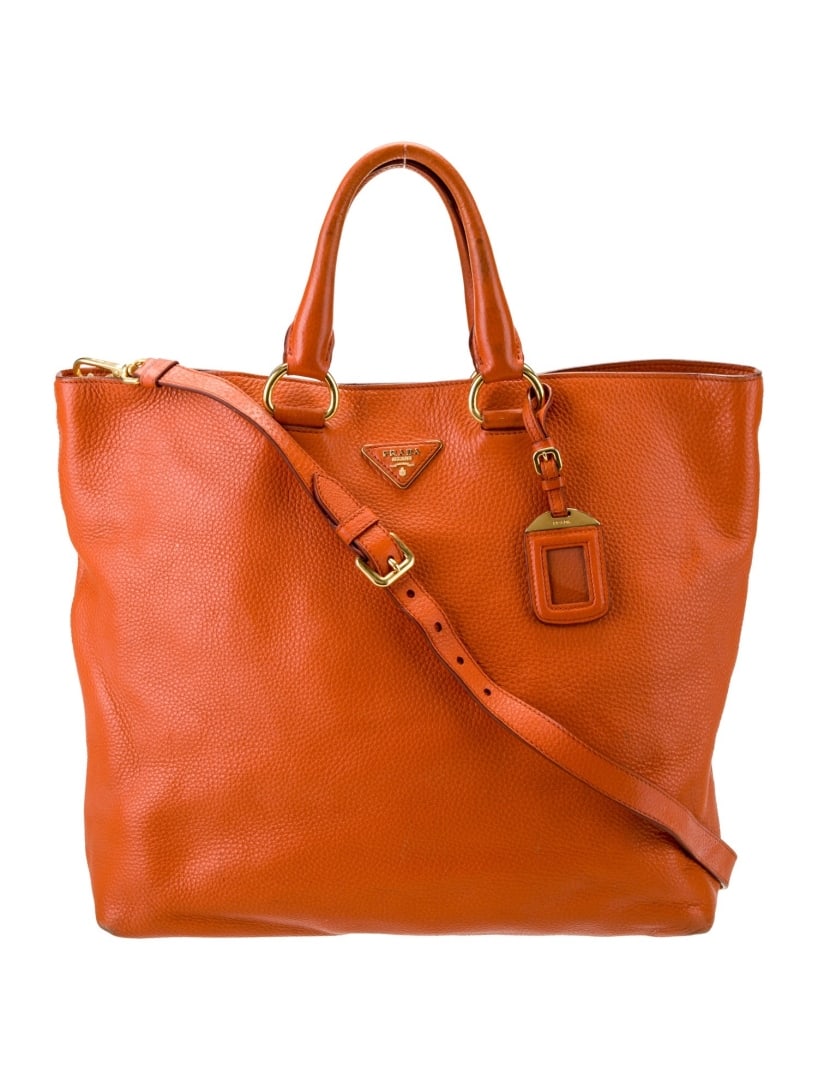 Prada Papaya Vitello Daino Leather Snap Cls Tote: Condition is: good, pre-owned. Details: papaya vitello daino leather, vitello daino leather, gold-tone hardware, rolled handles & single adjustable shoulder strap, logo jacquard lining & three interio