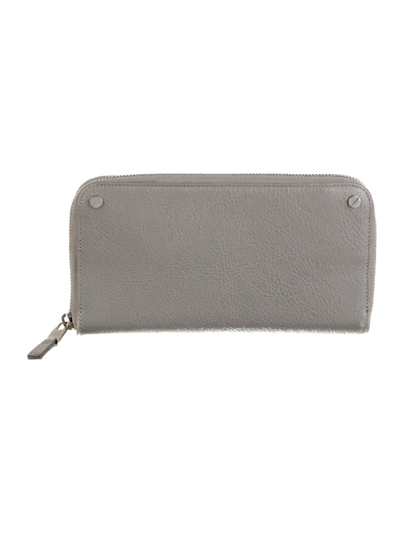 Balenciaga Grey 2016 Leather Continental Wallet: Condition is very good, pre-owned. Details: from the spring/summer 2016 collection by alexander wang, grey leather, silver-tone hardware, wrist strap, leather lining with card slots, exposed zip closu